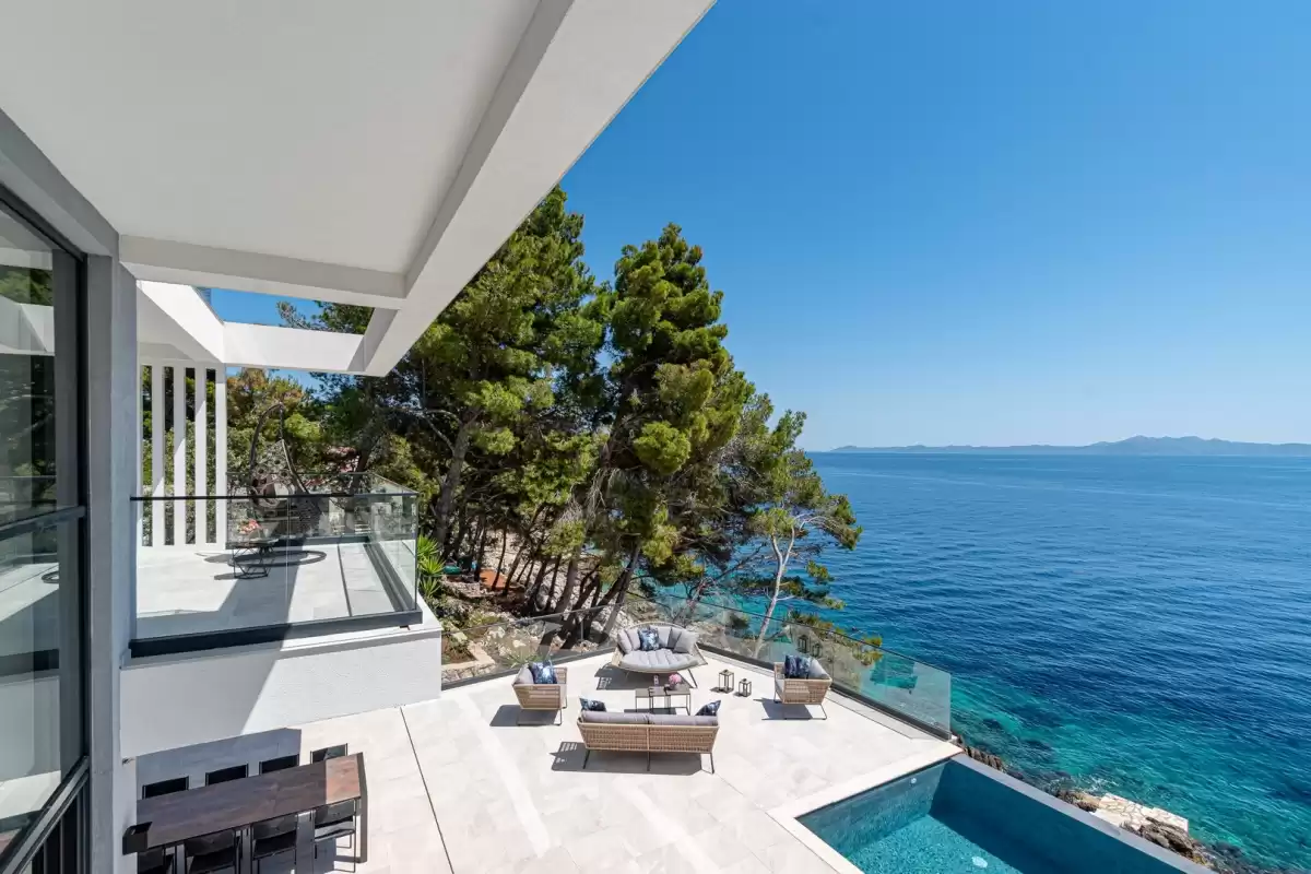 Terrace with outdoor lounge and pine trees above the Adriatic at Villa Sansarea
