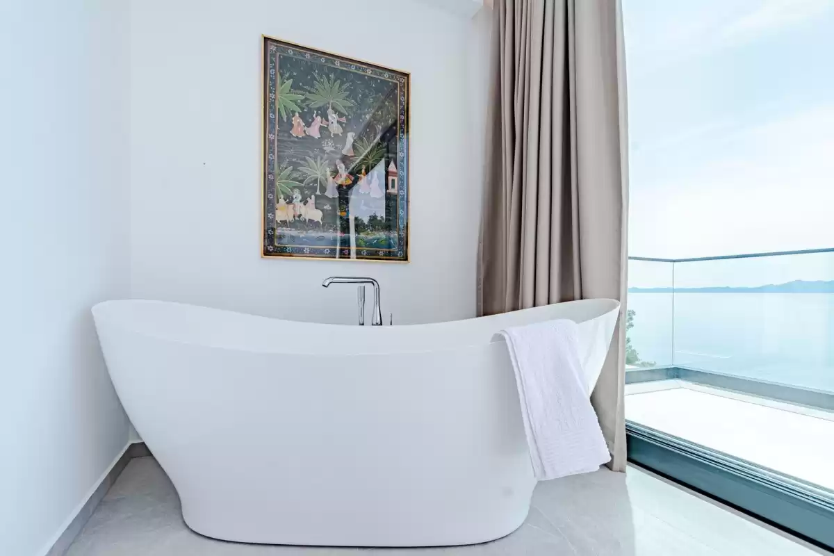 Freestanding bathtub by a window with sea views at Villa Sansarea