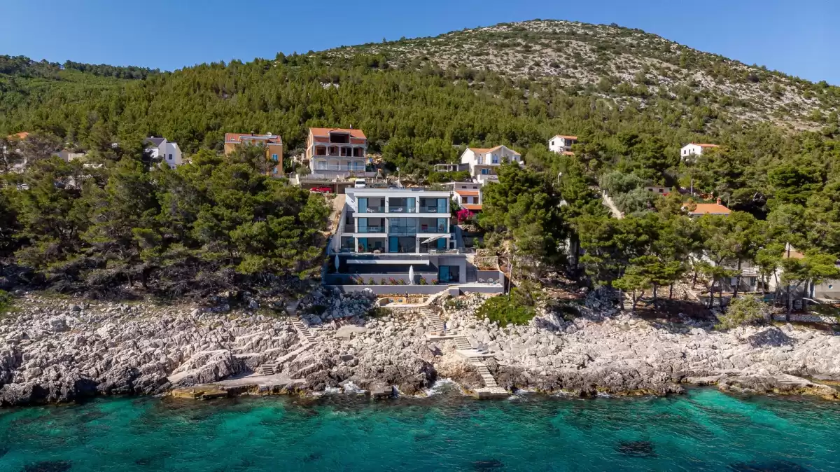 Villa Sansarea on the rocky shore with pine forest and turquoise sea, Korčula
