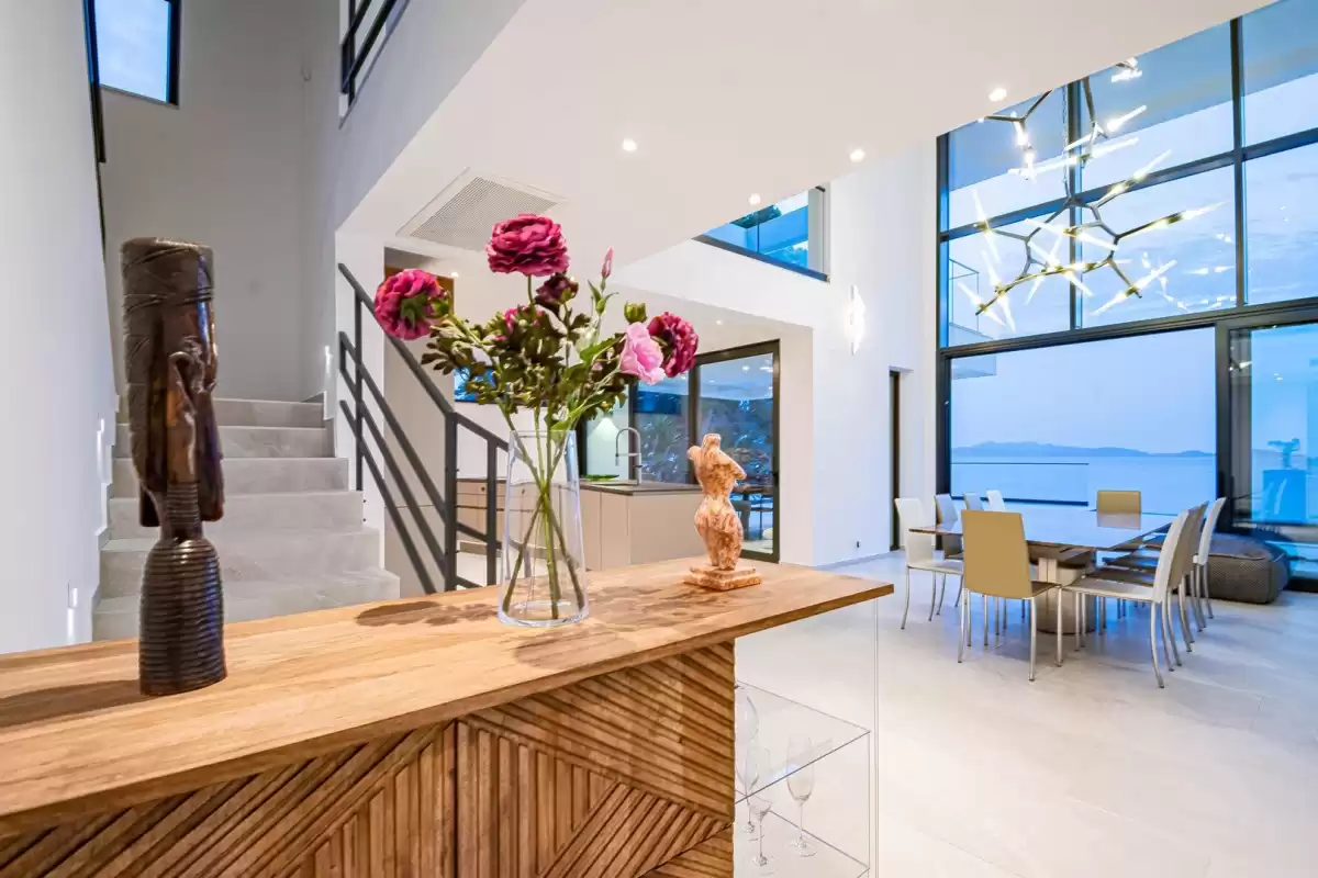 Entrance hall with staircase and flowers leading to the living area at Villa Sansarea