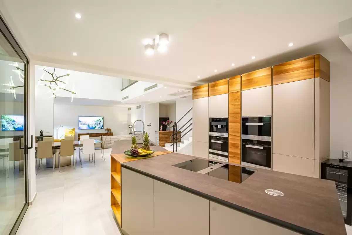 Modern kitchen with island and built-in ovens at Villa Sansarea