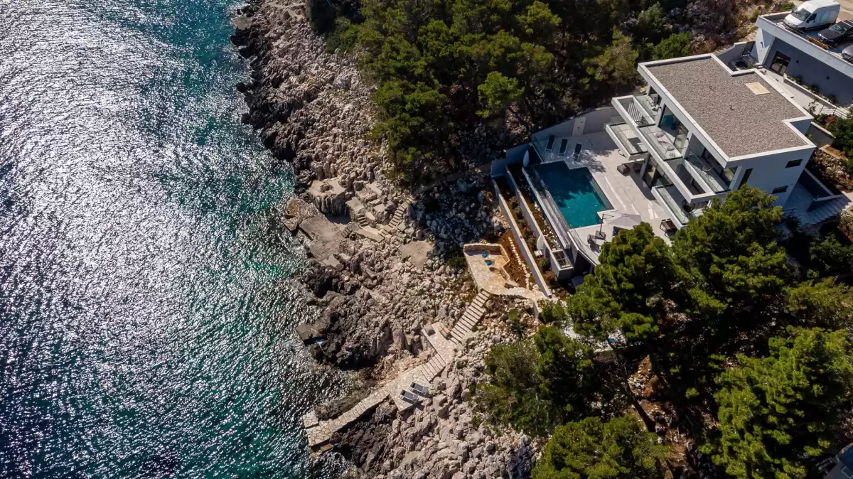 Aerial view of Villa Sansarea on the pine-covered cliffs above the sea near Blato, Korčula