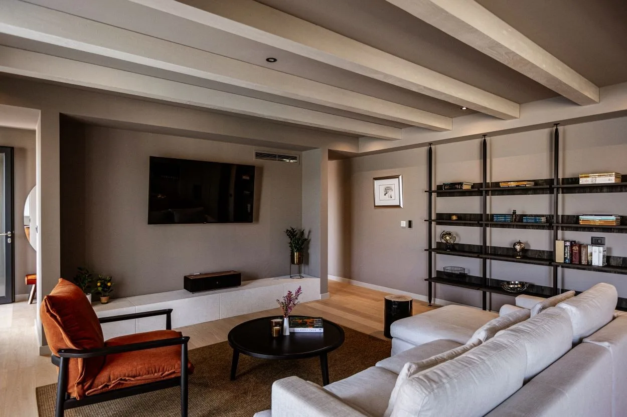 Living room with white sofa, armchair and bookshelves at Villa Sol