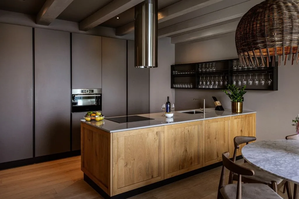Modern kitchen with wooden island and wine shelves at Villa Sol