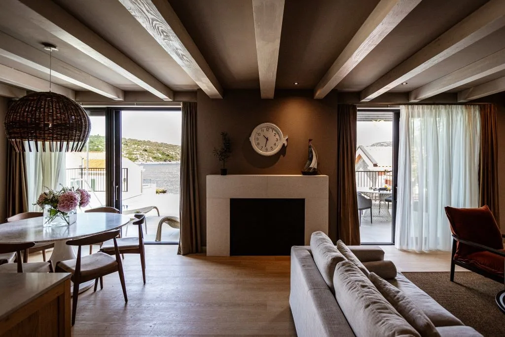 Living area with fireplace and dining table near the terrace doors at Villa Sol