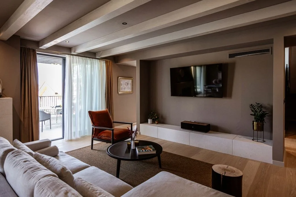 Living room with sofa and TV under beamed ceiling at Villa Sol, Slano