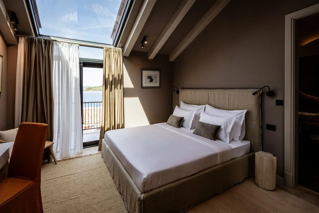 Bedroom with king-size bed and balcony doors with sea view at Villa Sol