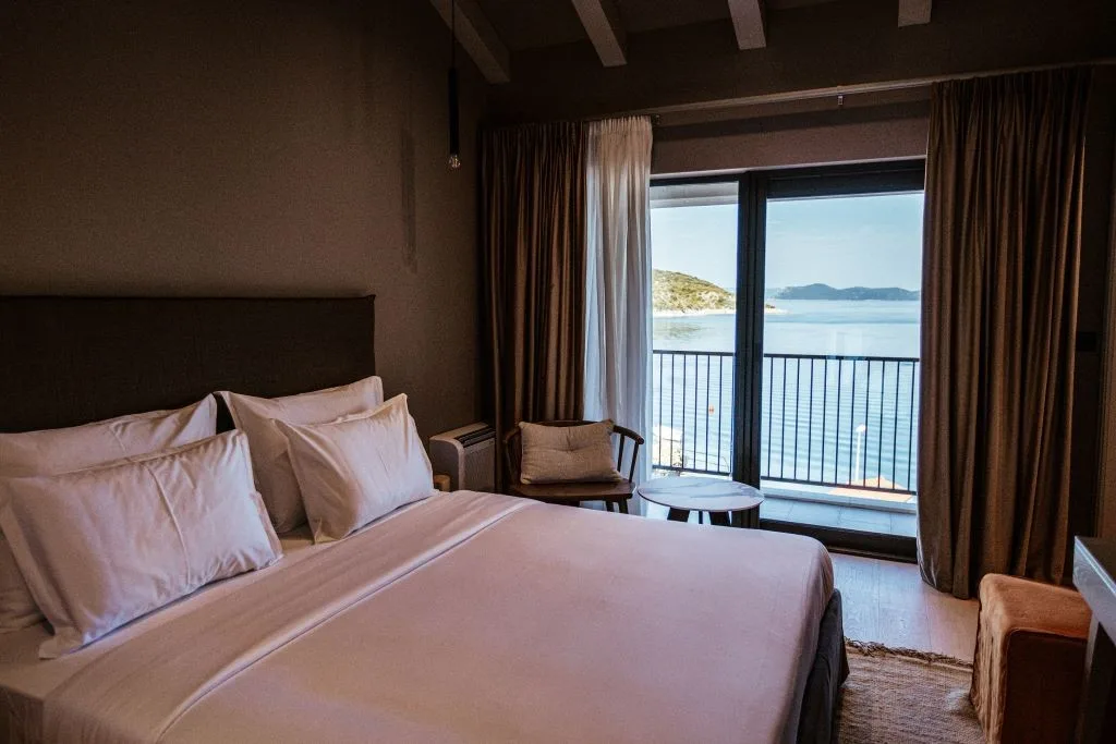 Bedroom with king-size bed facing the sea-view balcony at Villa Sol