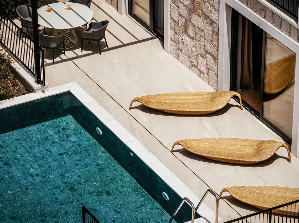 Green-tiled private pool with leaf-shaped sun loungers at Villa Sol