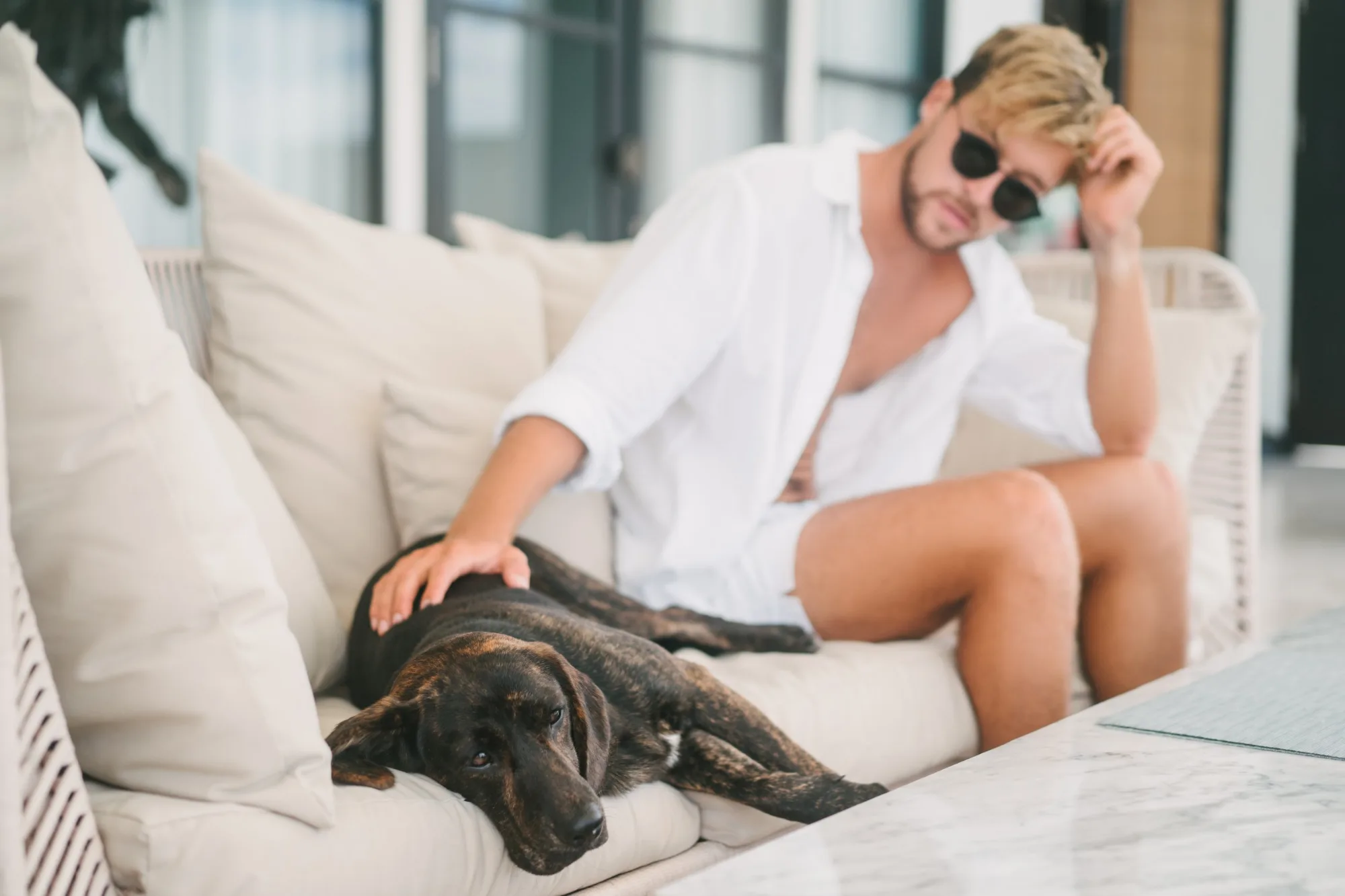 Guest relaxing on an outdoor sofa with his dog at a pet-friendly villa near Dubrovnik