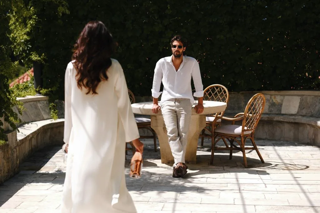 Couple on the stone garden terrace with stone table at Villa La Rose
